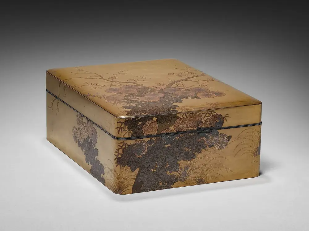 A low lidded document box photographed on a plain grey ground