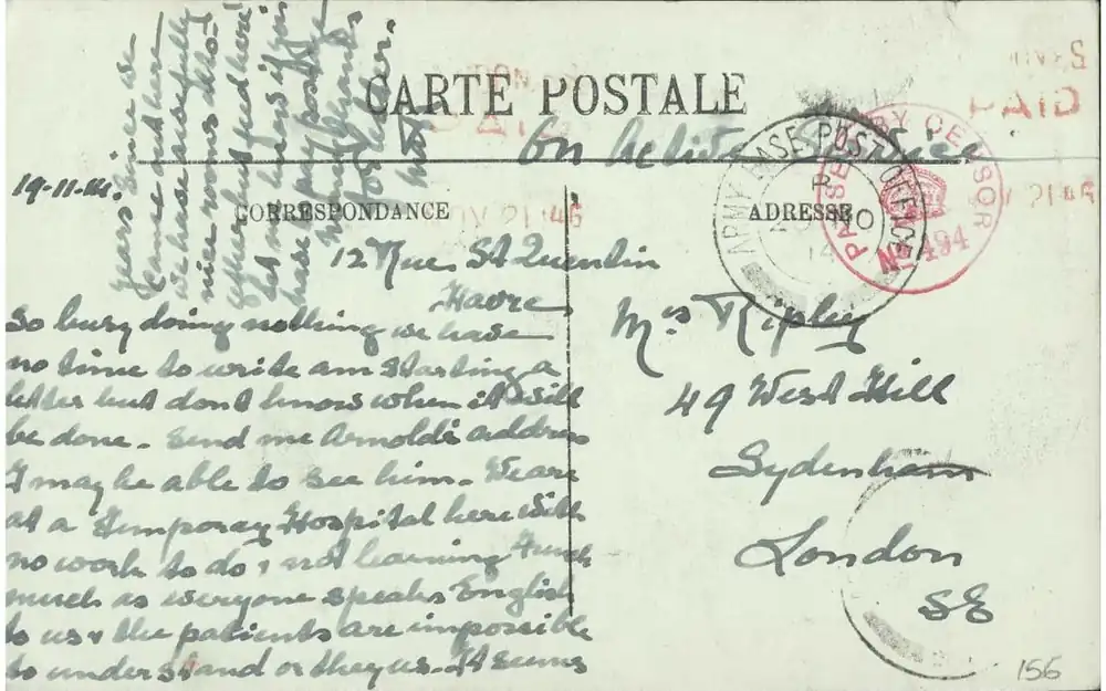 The handwritten back of a postcard from 1914 with red postmarks